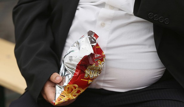 A man with a large belly eats junk food on May 23, 2013 in Leipzig, Germany.