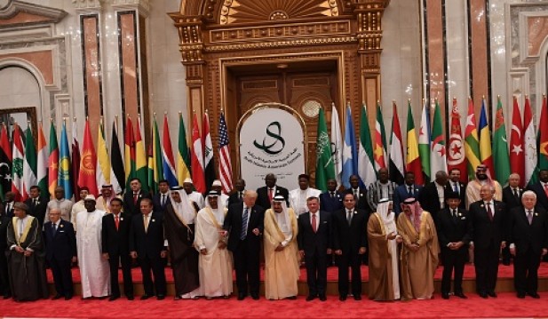 In this handout photo provided by the Palestinian Press Office, U.S. President Donald Trump joins Saudi Arabia's King Salman bin Abdulaziz al-Saud and other Arab leaders at a summit meeting May 21, 20