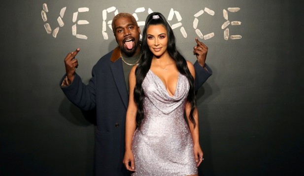 Kanye West and Kim Kardashian pose for a photo before attending the Versace presentation in New York