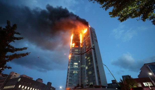 A mixed-use high-rise residential building is engulfed by a fire in Ulsan
