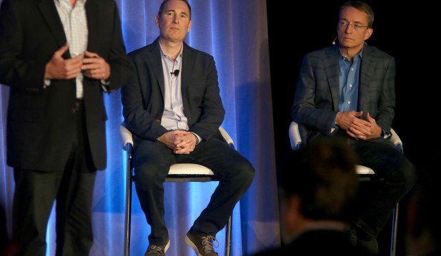 Western Digital CIO Steven Phillpott (left) speaks with CEO Andy Jassy (middle) and VMware CEO Parick P. Gelsinger (right) during a press conference announcing Amazon's cloud service, AWS, partnering with VMware Cloud creating a new integrated cloud serv