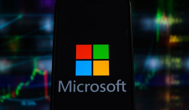 In this photo illustration a Microsoft logo seen displayed...