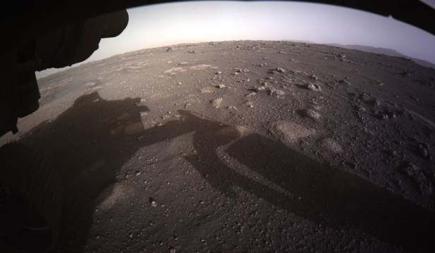 NASA's Ingenuity Captures Stunning Otherworldly Photo of Perseverance's Landing Capsule on Mars