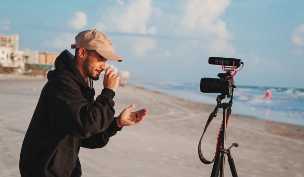 man in black jacket holding camera during daytime