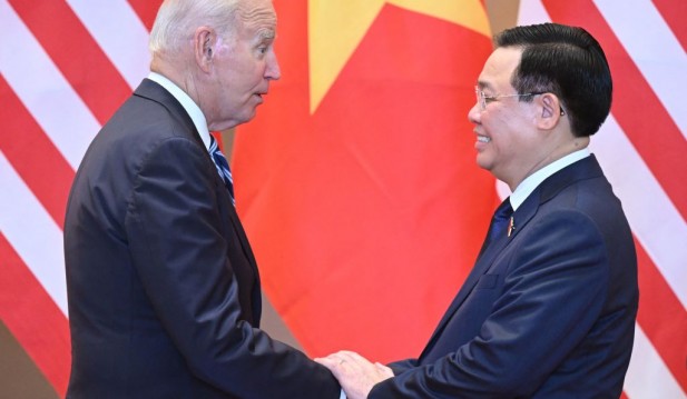 Chairman of Vietnam's National Assembly Vuong Dinh Hue shakes hands with US President Joe Biden 