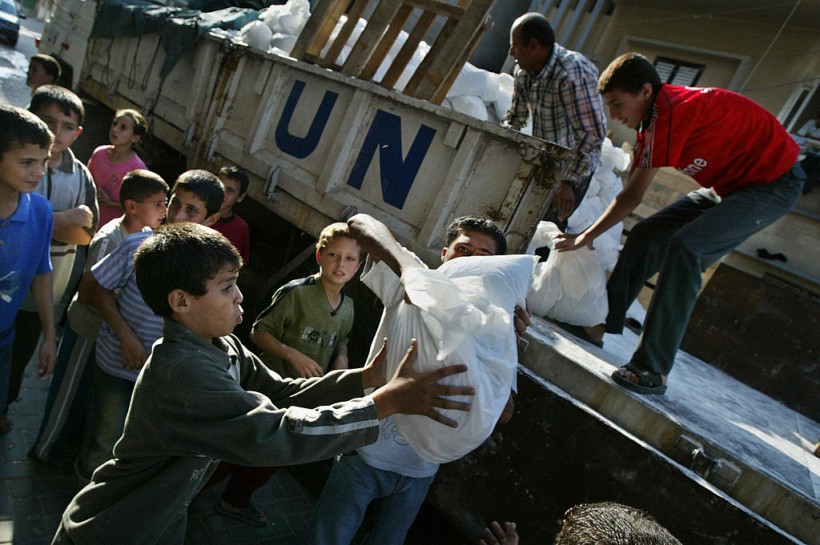 Palestinians receive food aid distribute