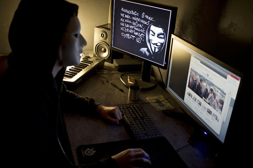 A masked hacker, part of the Anonymous g