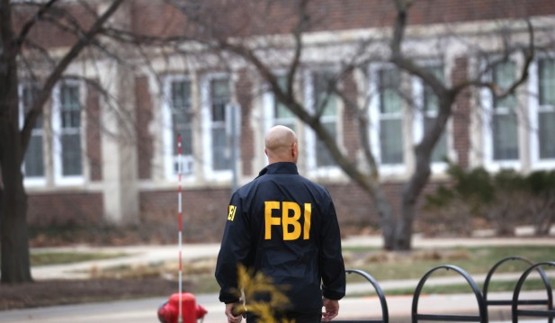  An FBI agent stands outside of Berkey Hall 