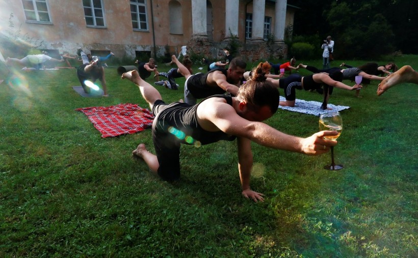 People perform wine yoga in Riga