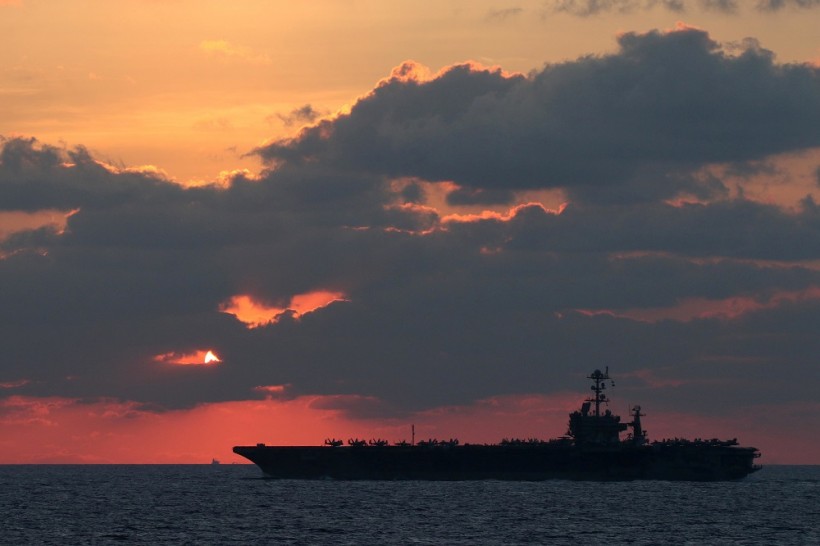 The U.S. Navy aircraft carrier USS John C. Stennis transits the South China Sea at sunset