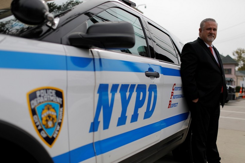Detective Raymond Wittick, 51, a Staten Island Welfare Officer with the Detectives' Endowment Association, poses with a New York Police Department (NYPD) vehicle on Staten Island in New York City