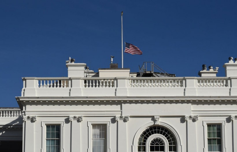 The US flag flies at half-mast above the White House