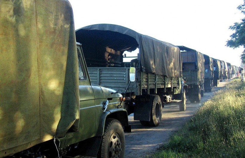 Myanmar military trucks carry away furni